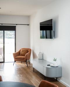 a living room with a chair and a table at 13th Beach Golf Lodges in Barwon Heads