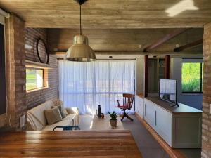 a living room with a couch and a tv at La Choza - Refugio para dos in La Falda
