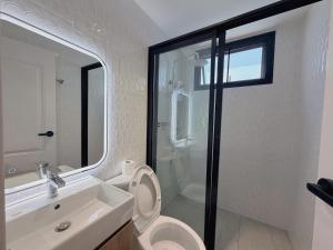 a bathroom with a toilet and a sink and a mirror at Four Moon Khaoyai in Pong Talong +38 photos