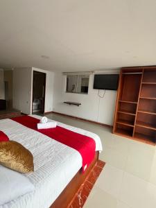 a bedroom with a large bed with a red blanket at Hotel Sabana Hilton in Madrid +46 photos