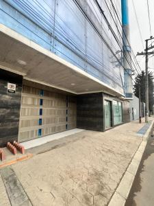 a building with a sidewalk in front of it at Hotel Sabana Hilton in Madrid