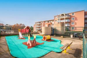 a play area with a playground with a slide at Moréa - residence avec piscine in Fréjus