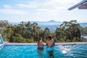 a man and a woman standing in a swimming pool at Wilderness House in Kulangoor