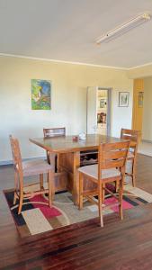 a dining room table with chairs and a wooden table at Bungles Ungalow in Castries
