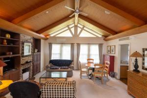 a living room with a ceiling fan and a table at フォレストヒルズガーデン in Mihara +112 photos
