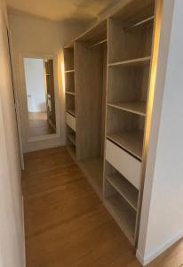 a walk in closet with wooden shelves and a mirror at Appartement 2 chambres, centre ville, proche mer in Saint-Nazaire
