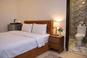 a bedroom with a bed and a toilet and a lamp at Hur palace pyramids view in Cairo