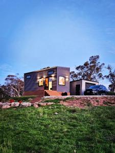 a small house with a car parked in front of it at Wuelf & the Fallow in Moonbah