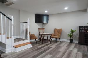 a living room with a table and chairs and a tv at Gateway Getaways in Hagerstown