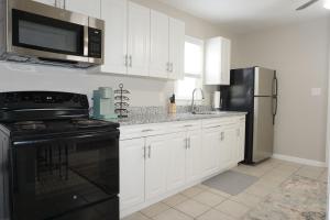 a kitchen with a black stove and a refrigerator at Gateway Getaways in Hagerstown