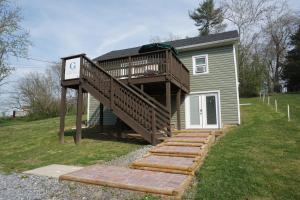 a house with a deck with a clock on it at Gateway Getaways in Hagerstown