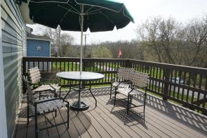 a patio with a table and chairs and an umbrella at Gateway Getaways in Hagerstown +4 photos