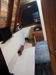 an attic room with a staircase and a door at Chalés FRONT LAKE 1 in Córrego do Bom Jesus +18 photos