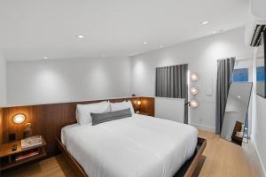 a bedroom with a large white bed in it at Hotel SOMA in Fort Worth