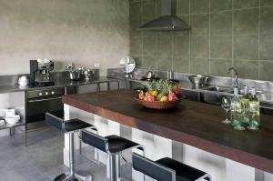 a kitchen with a bowl of fruit on a counter at THE VILLA @ RED BRIDGE in Hoi An
