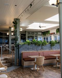 a restaurant with plants on a brick wall at 13th Beach Golf Lodges in Barwon Heads
