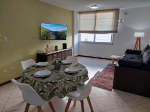 a living room with a table and chairs and a couch at Mirasol in Villa Carlos Paz