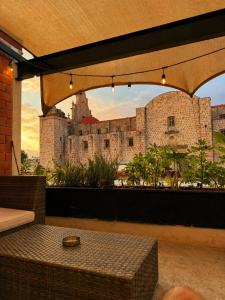 a view of a castle from a patio with a table at El Suburbio - Aldama in Morelia