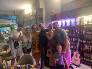 a group of people posing for a picture in a store at The Vinyl Homestay in Ho Chi Minh City