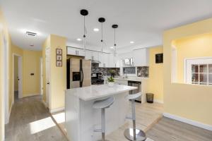 a kitchen with a white counter and yellow walls at Gn4 - Sleek Private Room Ideal for Remote Work, Wi-Fi, Free Parking in Beech +5 photos