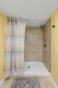 a bathroom with a shower with a shower curtain at Gn4 - Sleek Private Room Ideal for Remote Work, Wi-Fi, Free Parking in Beech