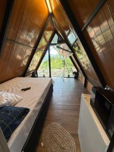 a bedroom in a tent with a bed in it at Chalé refugio de Igaratá in Igaratá +3 photos