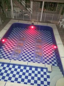 a swimming pool with two mats on a chess board at Hotel El Escorpión in Melgar +4 photos