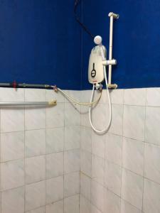 a shower in a bathroom with a blue wall at Surf house langkawi in Pulau Tepur +112 photos