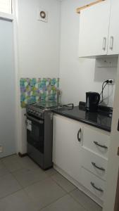 a kitchen with a stove and a counter top at Casa Linares in Linares +4 photos