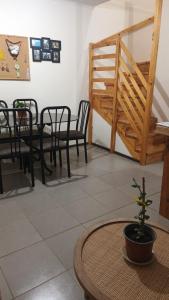 a dining room with chairs and a table and a stairway at Casa Linares in Linares