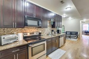 a kitchen with stainless steel appliances and wooden cabinets at Private Room | Temple | Fast WiFi | Kitchen V in Philadelphia