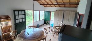 a room with a table with chairs and a large artifact at Hostal LA MIA in Armenia