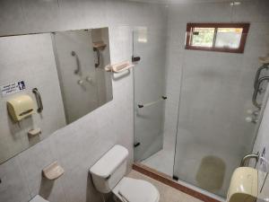 a bathroom with a shower and a toilet and a sink at Hostal LA MIA in Armenia +48 photos