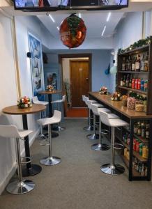 a bar in a restaurant with stools in a room at Giza City Hotel-الجيزة سيتى اوتيل in Cairo