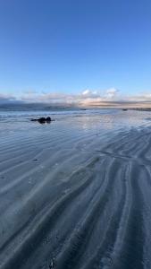 an empty beach with tracks in the sand at Casa de playa con espectacular vista in Islote Ramadas +13 photos
