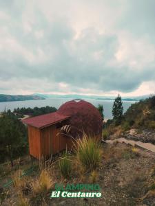 a smallshed sitting on top of a hill with water at Glamping Centauro in Tota