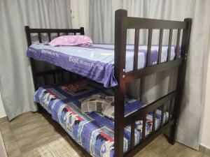 two bunk beds in a room with a crib at Maxi&Mia Cabañas in Coveñitas