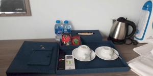 a table with two blue boxes and bottles of water at Bamboo Hotel FLC Sầm Sơn in Sầm Sơn +6 photos