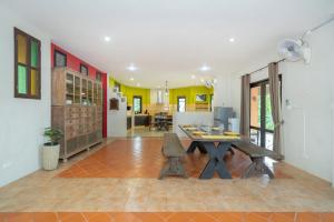 a dining room with a table and chairs in a room at Nature's Hill side Phana House in Phuket