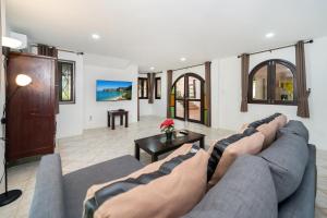 a living room with a couch and a table at Nature's Hill side Phana House in Phuket