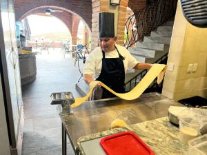 a man in a kitchen preparing food on a counter at Quinta Maria Cortez Beach Hotel in Puerto Vallarta +134 photos