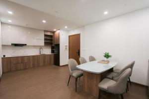 a kitchen and dining room with a table and chairs at Prime Hotel in Thái Nguyên