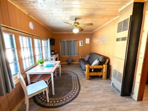 a living room with a table and a couch at 2BR 1BA Cabin #2 Riverside Point Resort in Park Rapids