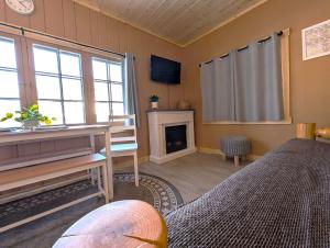 a bedroom with two beds and a fireplace at 2BR 1BA Cabin #2 Riverside Point Resort in Park Rapids