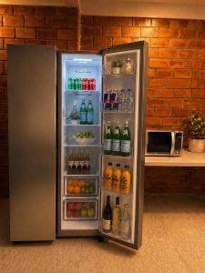 a refrigerator filled with lots of soda and drinks at El Suburbio - Aldama in Morelia