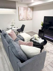 a living room with a couch and a piano at Velvet and Rose Elegant Private 2BR Basement Suite in Winnipeg