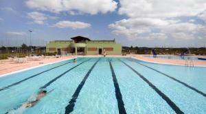 a large swimming pool with people in the water at Ferreira do Alentejo Terrace Rustic Villa in Beja