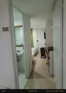 a bathroom with a toilet and a sink and a tub at Hotel Fegali Art Boutique in Cartagena de Indias +36 photos