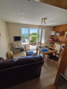 a living room with a couch and a table at Westcliffe chalets channel view in Niton
