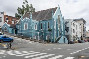 a blue building on the side of a street at Chapel On Moray - Apartment in Dunedin